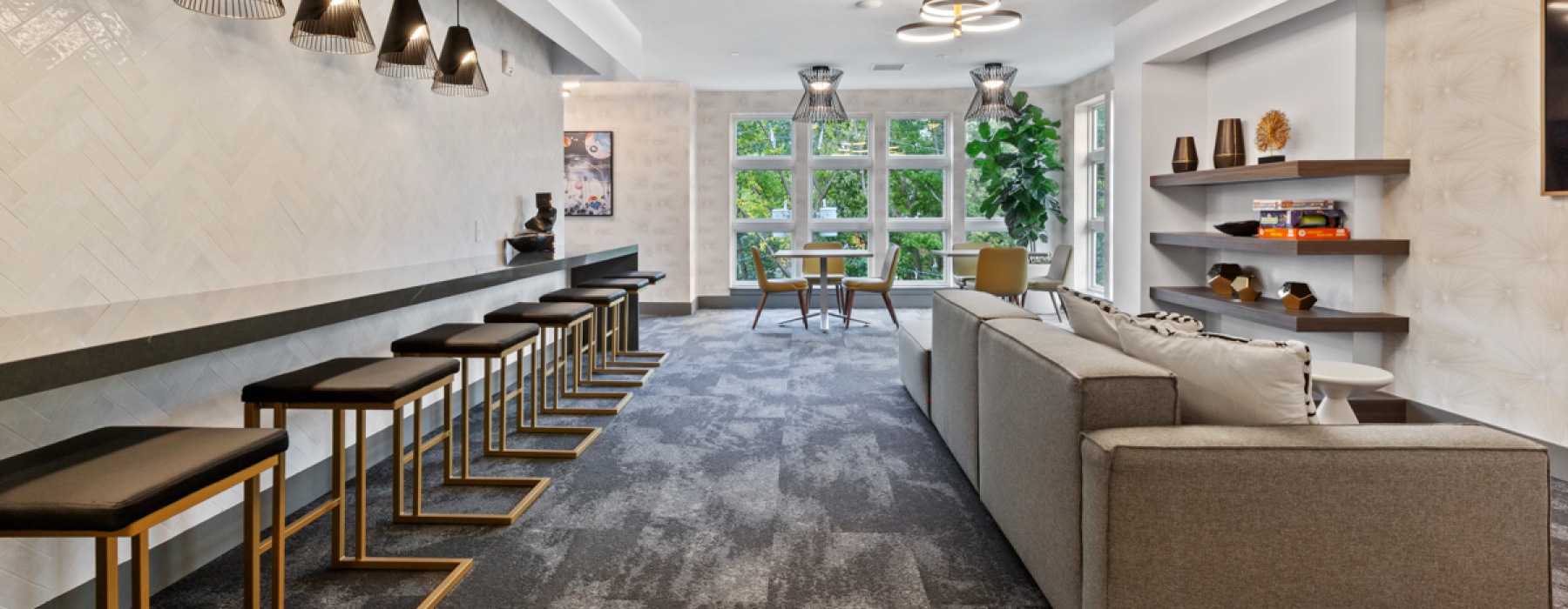 Resident lounge with various seating areas and art TV