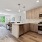 wide kitchen with open counter next to dining area
